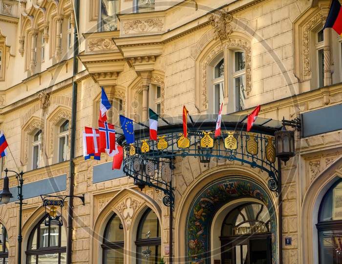 National Flags Above The Entrance To An Old Hotel Building In Prague, Czech Republic