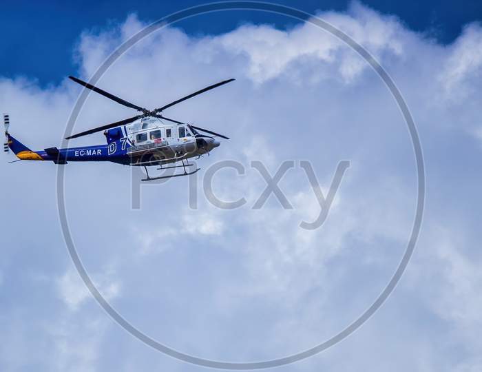 Ronda, Spain - September 06, 2015: A Spanish Faasa Bell 412 Ec-Mar Flying Over Ronda Against Cloudy Sky