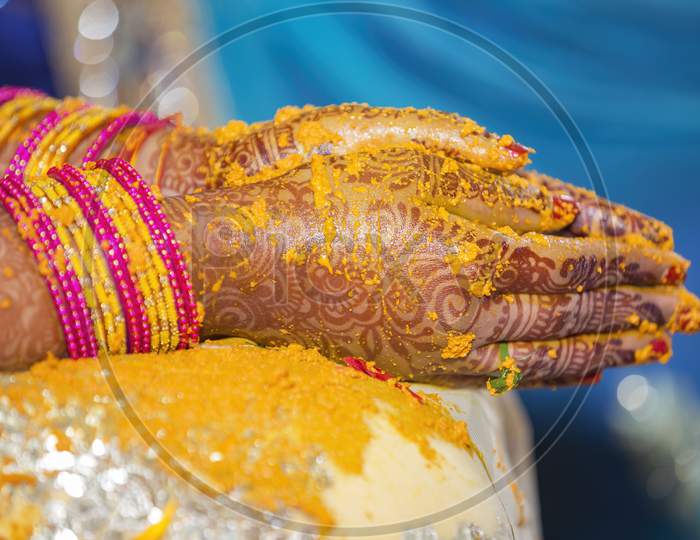 henna and fresh turmeric paste on Indian bride's hands
