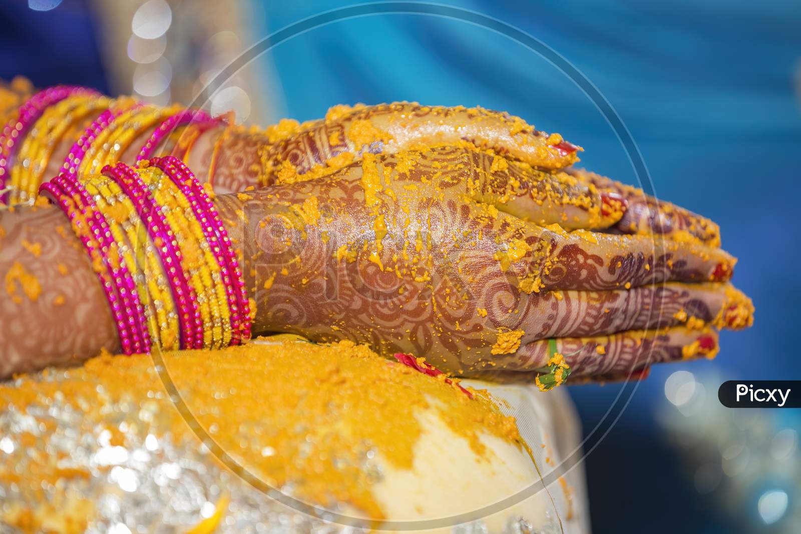 henna and fresh turmeric paste on Indian bride's hands