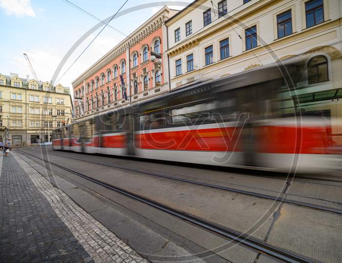 Tram With Motion Blur Through Cobbled Streets Of Old Town District Of Prague