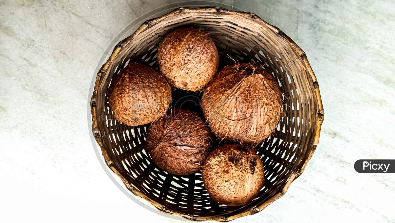 Indian fresh coconut in the basket for sell.