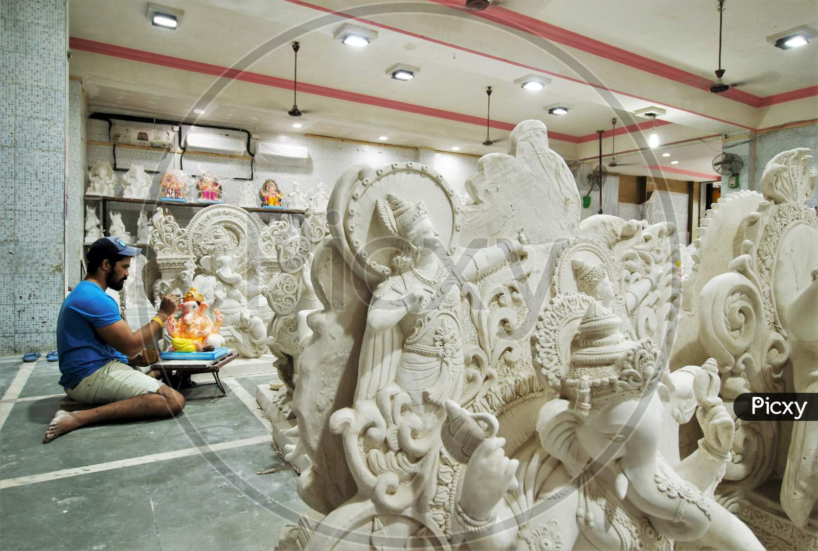 A man works on an idol of Hindu god Ganesh, the deity of prosperity, before the Ganesh Chaturthi festival, at a workshop in Mumbai, India, July 23, 2020.