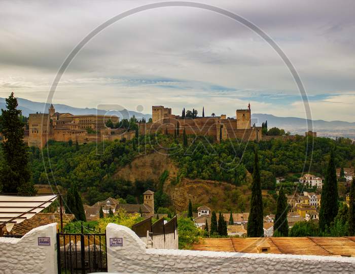 Granada, Spain - September 05, 2015: Wide Angel View Of Alhambra Castle Against Dramatic Sunset