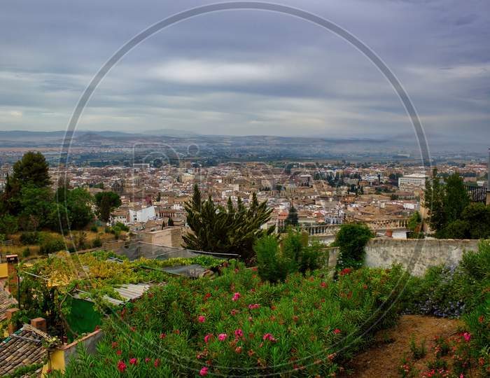 Beautiful Wide Angle Scenic View Of Granada City Located In Southern Spain, Andalusia Against Dramatic Clouds, Europe