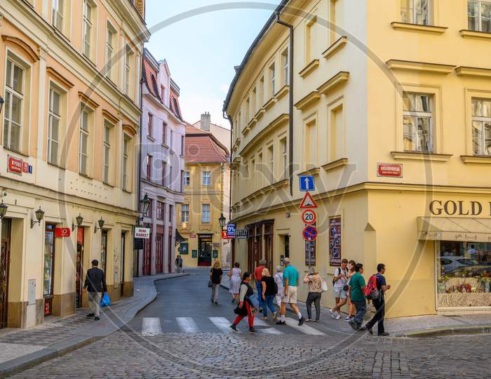 Tourists Exploring The Old Streets Lined With Beautiful Buildings In Prague, Czech Republic
