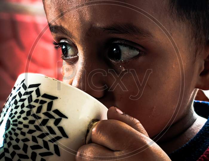 Small child drinking tea