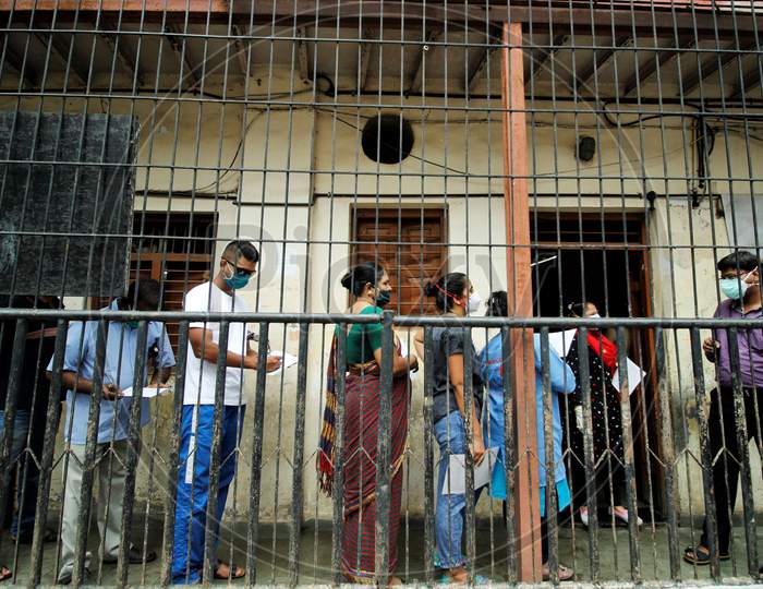 Recovered covid-19 patients wait in a queue as they arrive for screening for plasma donation, at a camp set inside a classroom of a school, at Dharavi, in Mumbai, India on July 23, 2020.