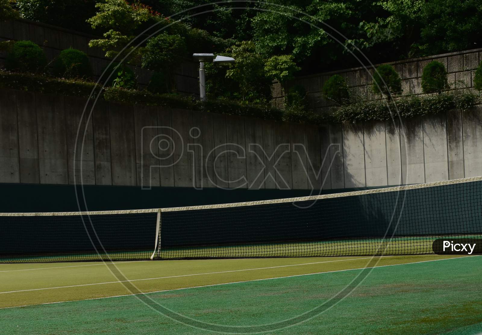 The empty tennis court under the strong sun in Tokyo Japan