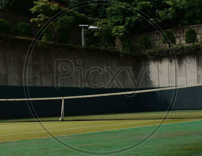 The empty tennis court under the strong sun in Tokyo Japan