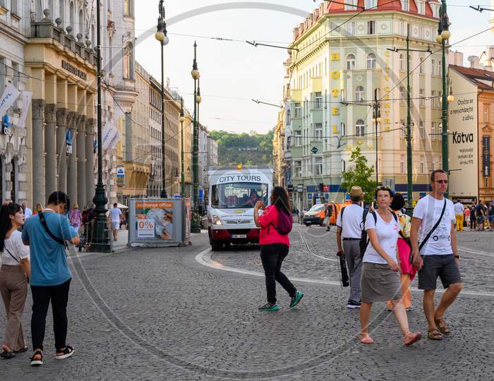Tourists And Small City Tours Bus On The Cobbled Streets Of Republic Square, Prague, Czech Republic