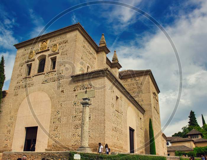 Granada, Spain - September 05, 2015: Wide Angle View Of Medieval Complex Housing Palace Exterior In Alhambra Castle Against Blue Sky