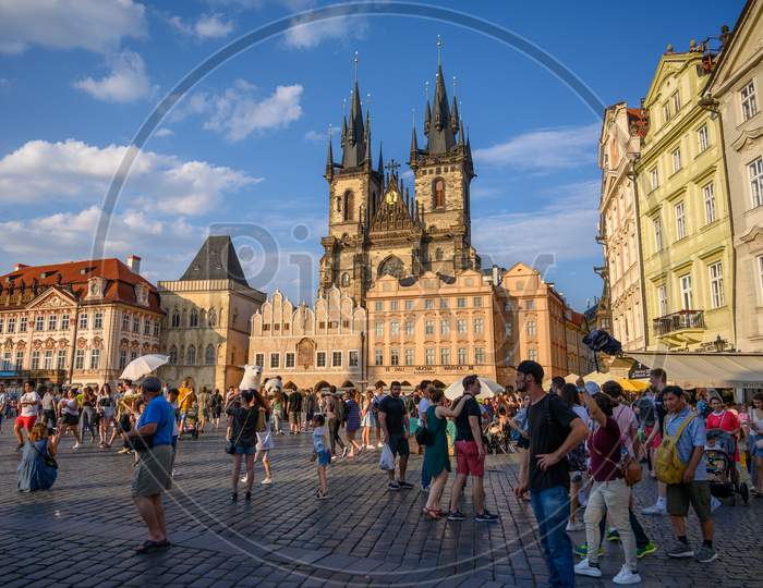 Busy Tourist Scene In The Old Town Square, Prague, Czech Republic With The Church Of Our Lady Before Týn In The Background