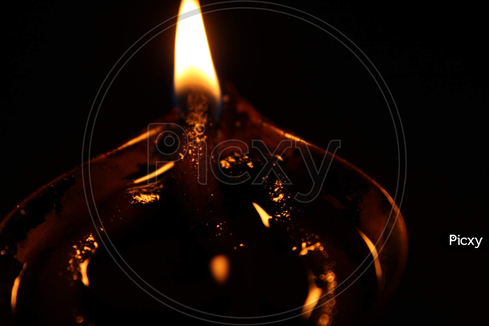 Burning oil lamp and fire with dark background. Closeup.
