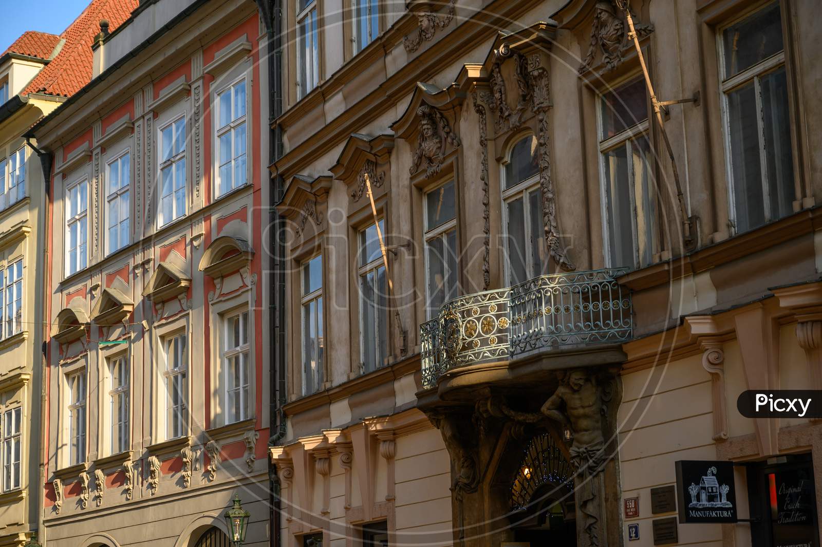 A Sunlit Balcony On The Side Of Old Buildings In Prague, Czech Republic
