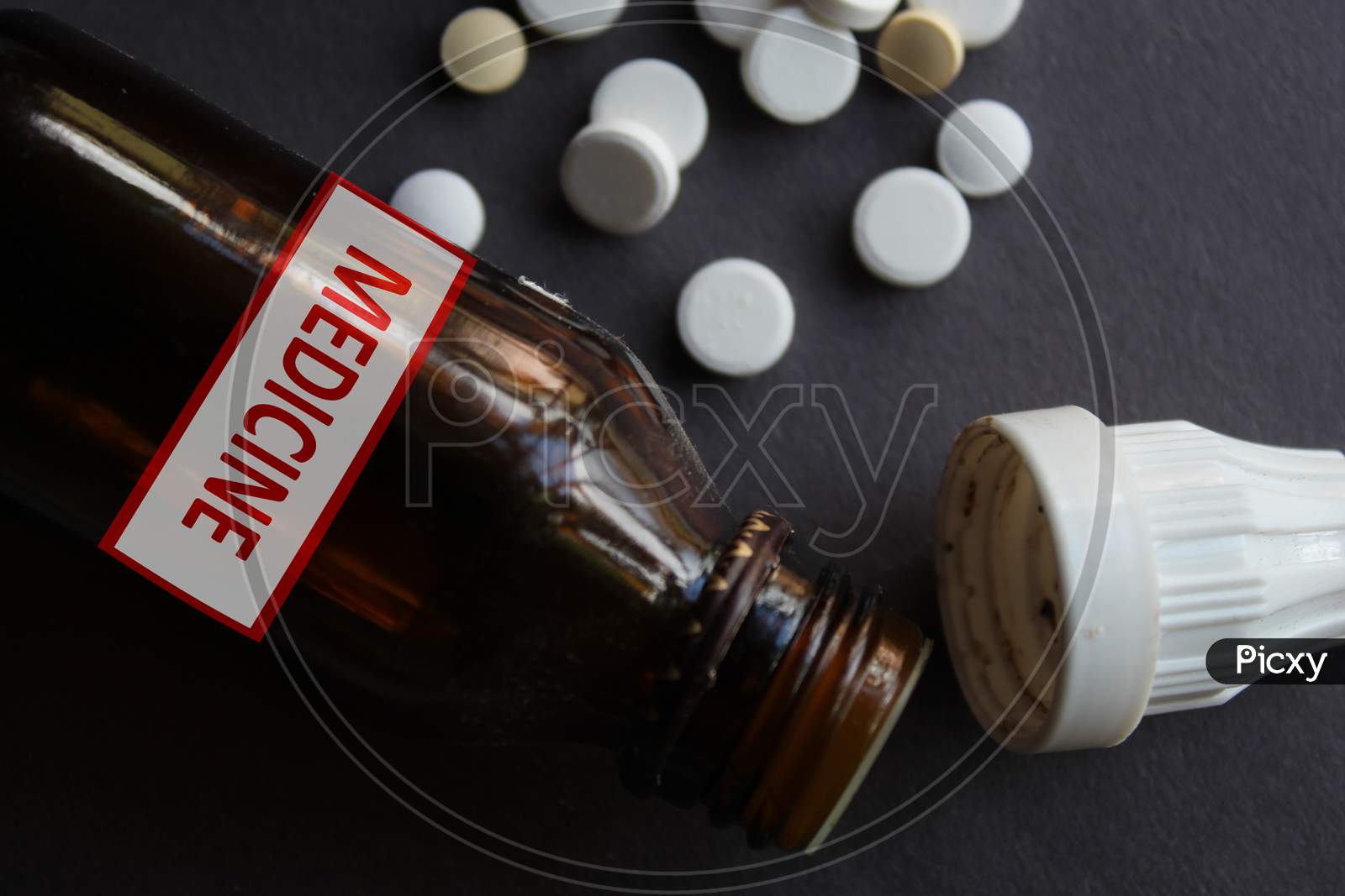 Medicine written container and tablets, pills together as pharmacy and medical theme background.