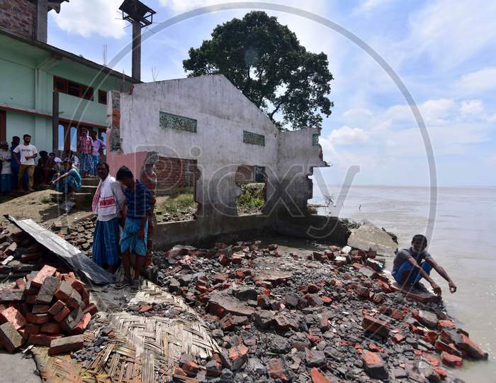 Villagers Stand Next To A School And Mosque That Collapsed On The Banks Of Brahmaputra River Owing To Soil Erosion, At Bhurbandha Village In Nagaon District Of Assam On July 25, 2020.