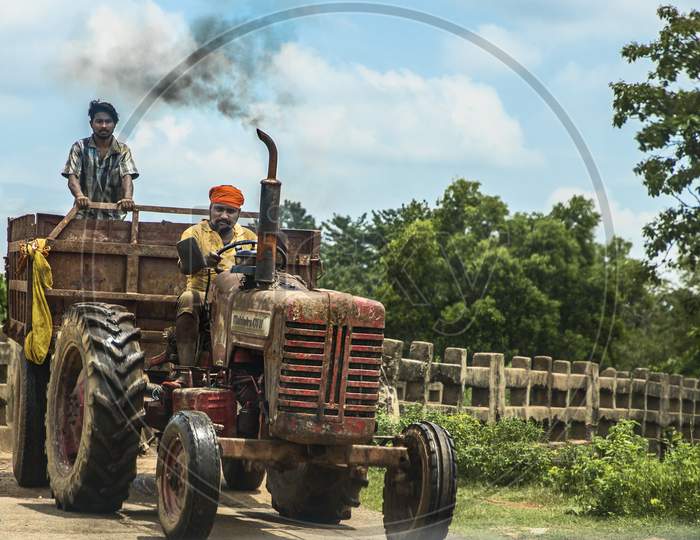 An Indian driving tractor