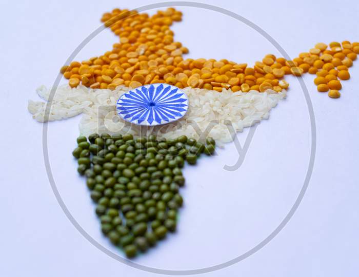 Indian map made with pulses and rice, arhar dal, rice, moong dal, side view, focus at ashok chakra, with white background, image