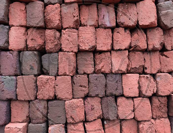 Stacked red bricks ready for construction，Toned image.