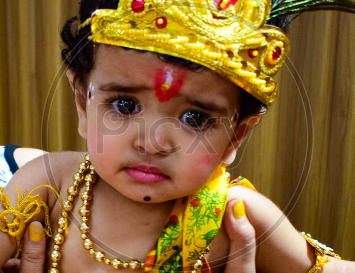 Cute Indian Kid dressed up as little Lord Krishna on the occasion of Krishna Janmastami Festival in Delhi India