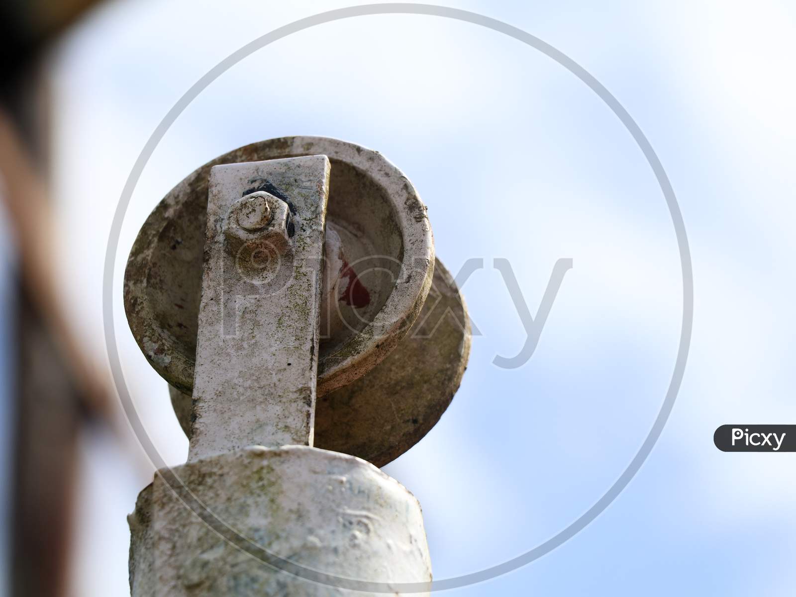 Low Angle Shot Of An Old Well Pulley Against Sky, Vintage