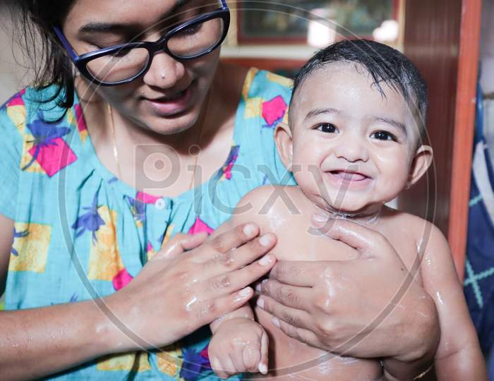 An Infant Toddler Baby Boy Wet With Foam Enjoying Shower Bathing With Mother