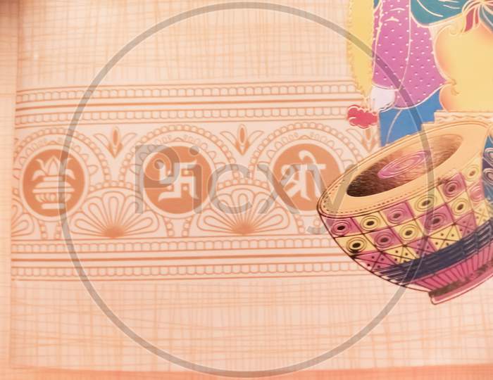 Swastik symbol on Indian traditional wedding invitation card.