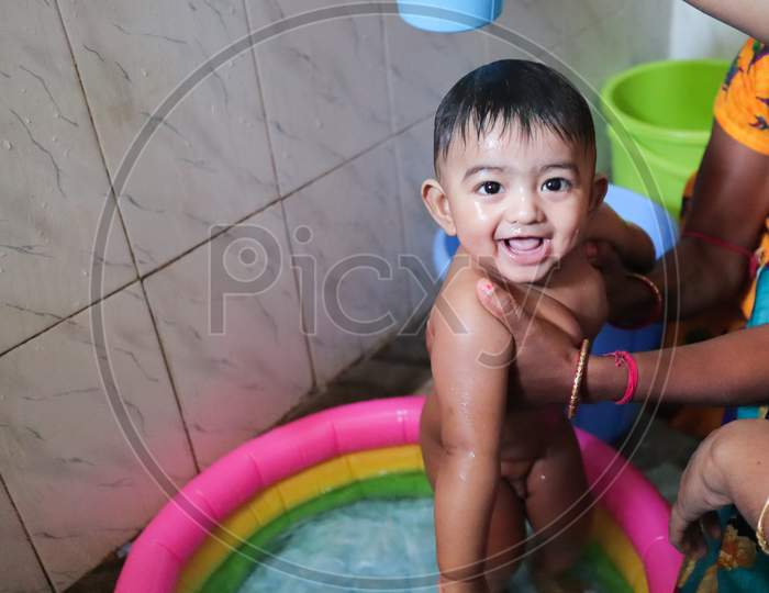 An Infant Toddler Baby Boy Wet With Foam Enjoying Shower Bathing