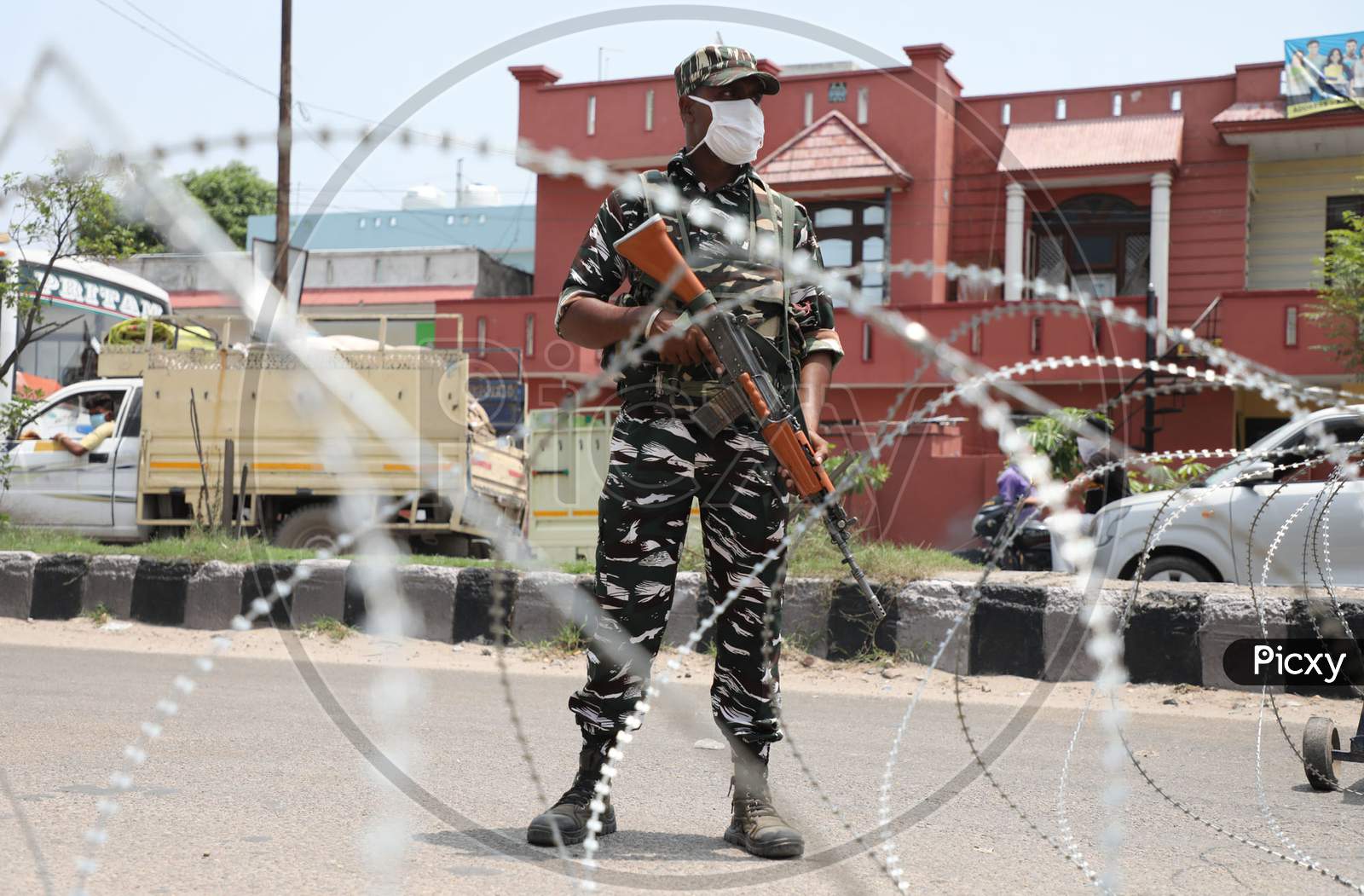 Paramilitary soldiers stand guard outside a containment area as authorities imposed weekend lockdown from 6 pm Friday to 6 am Monday, in Jammu on July 22, 2020.