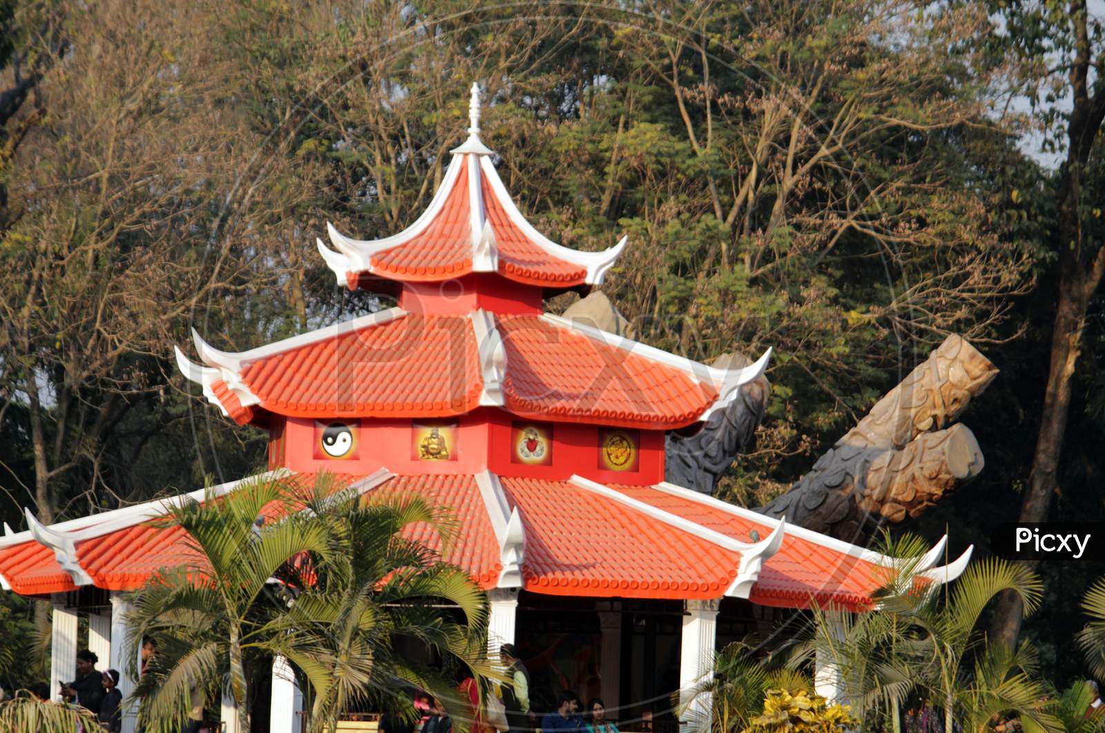 Red White colored Buddhist Temple shaped structure with sky and nature around at "Shivaji Park" on Sunday evening at Barasat, North 24 Parganas.