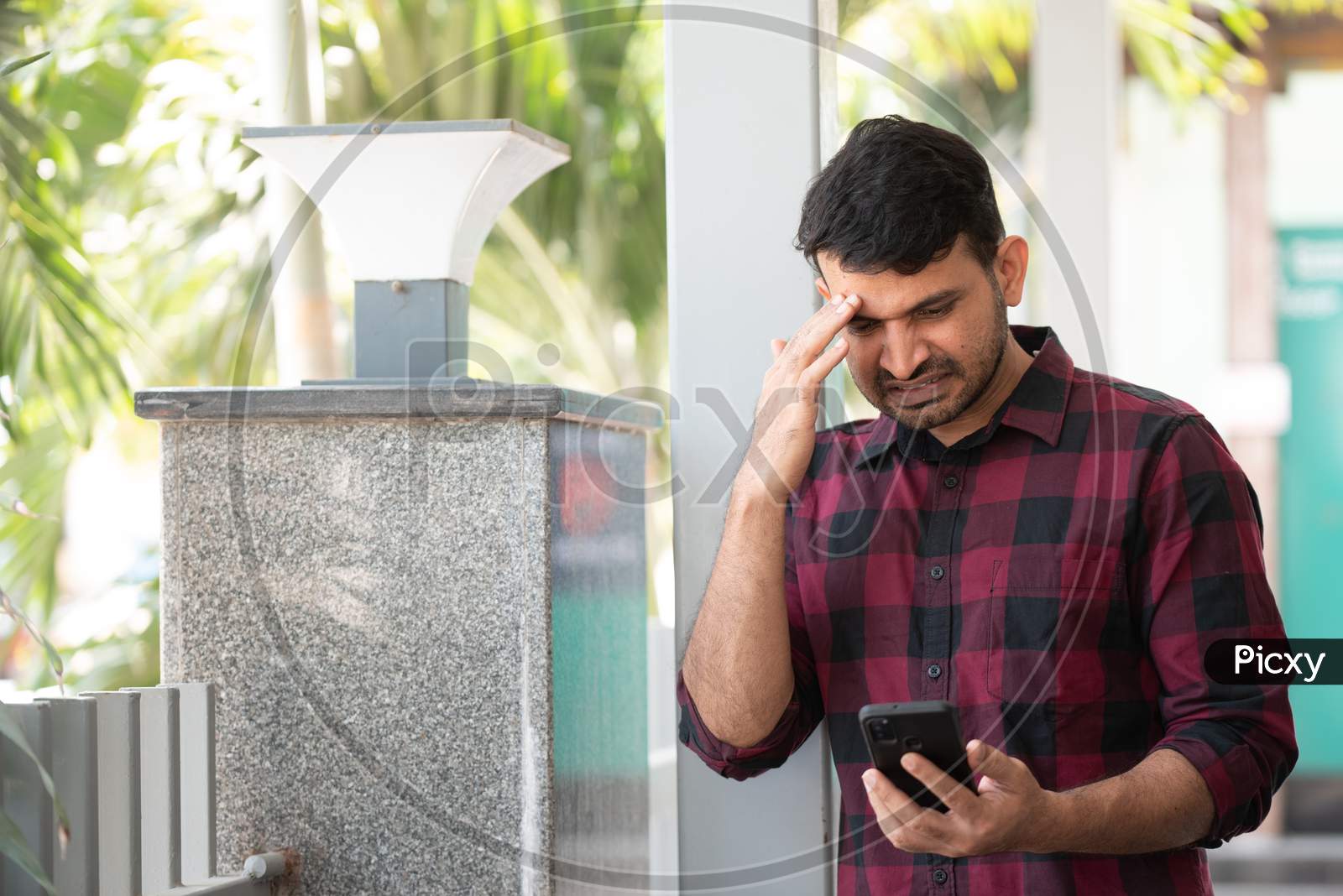 Portrait of a Young Indian Man makes gestures while talking on a video call.