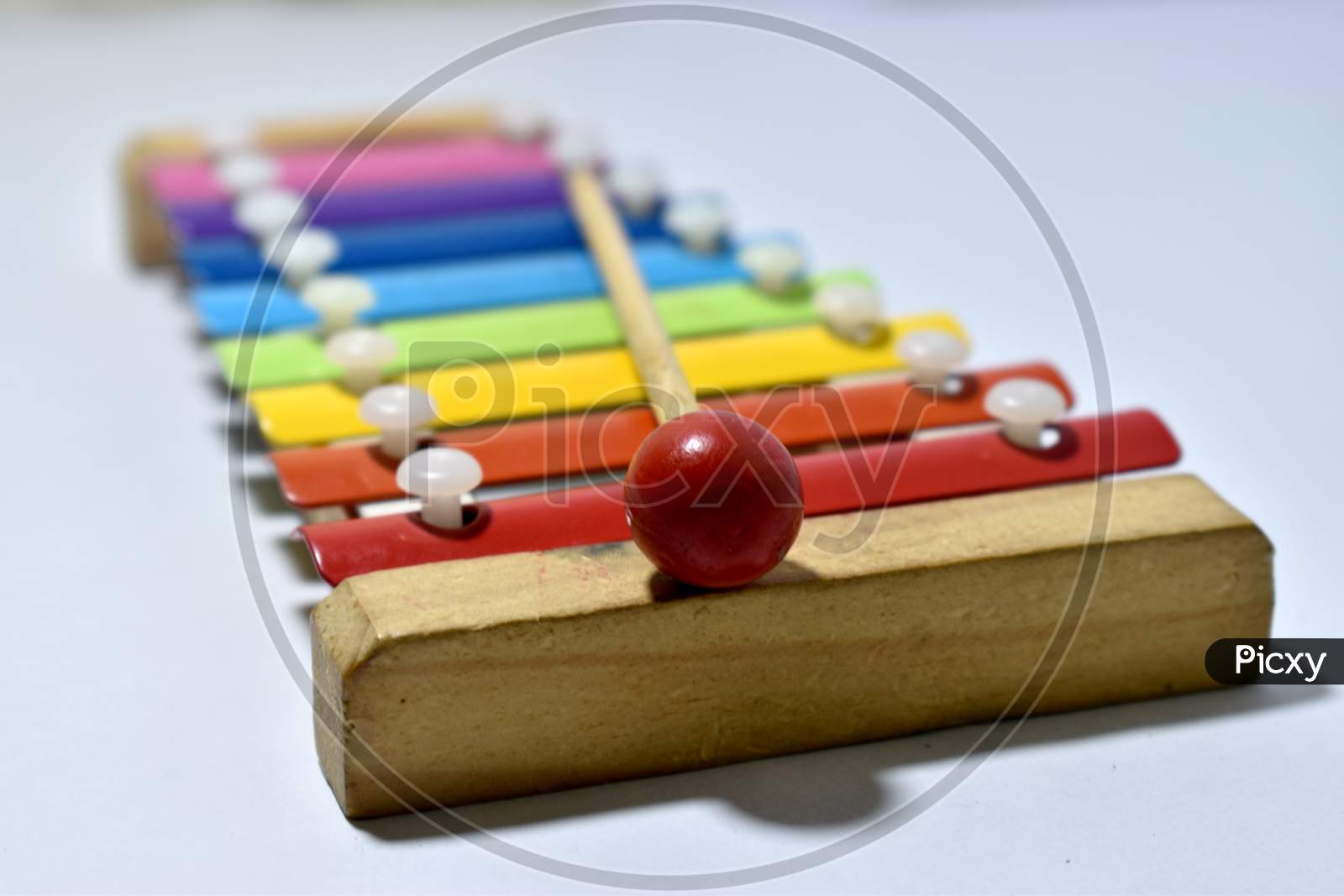 Rainbow colored toy xylophone isolated on white background. Bokeh - Shallow Depth of field.