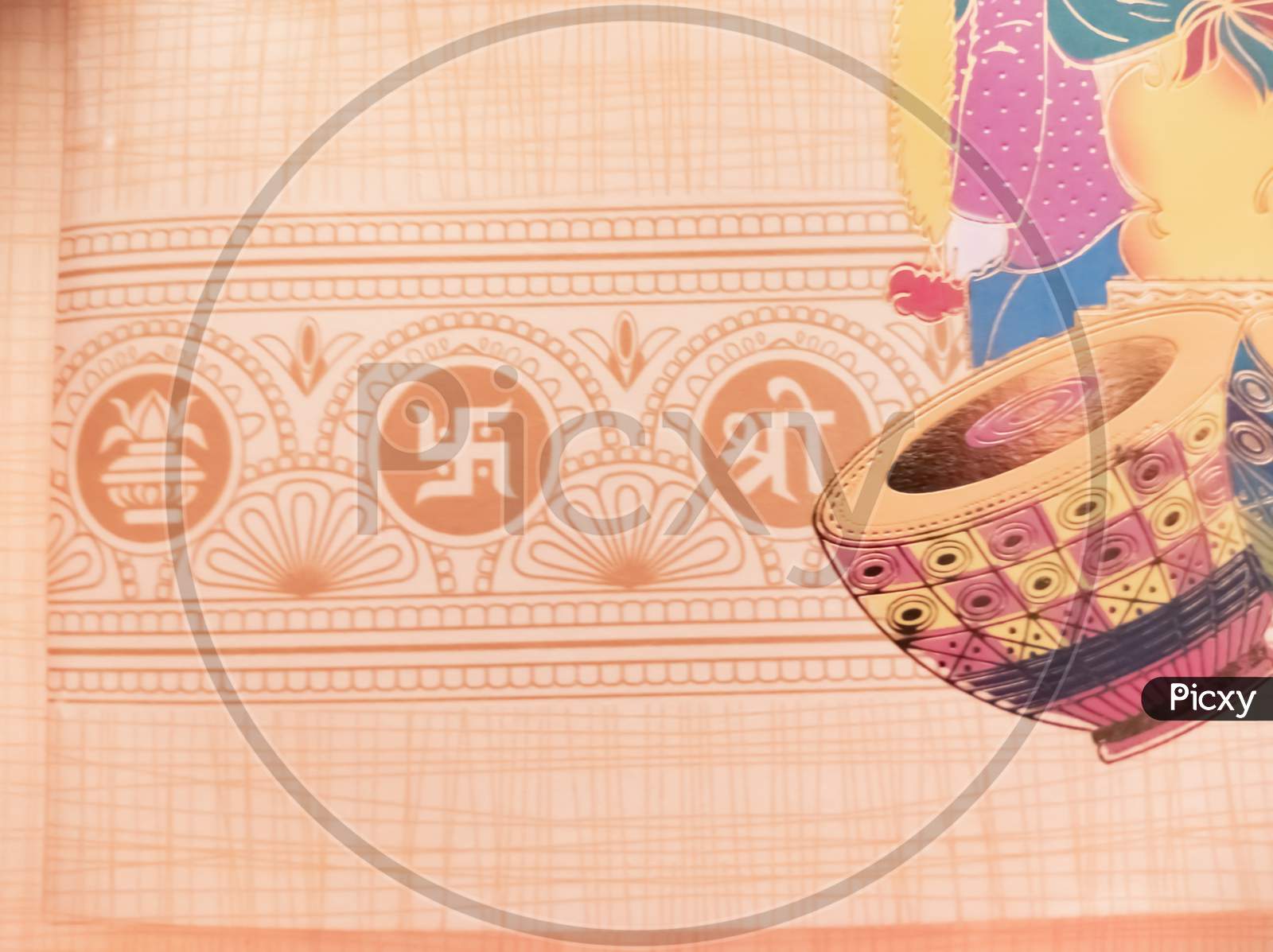 Swastik symbol on Indian traditional wedding invitation card.