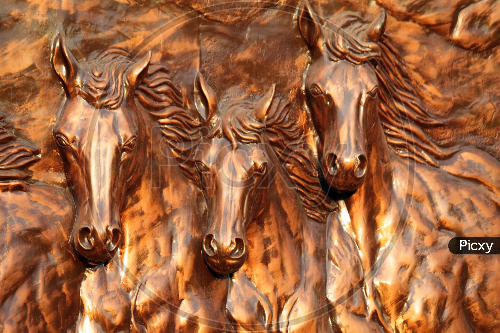Metal looking horses cropped statue on wall display with selective focus at "Shivaji Park" on ,Barasat, North 24 Parganas.