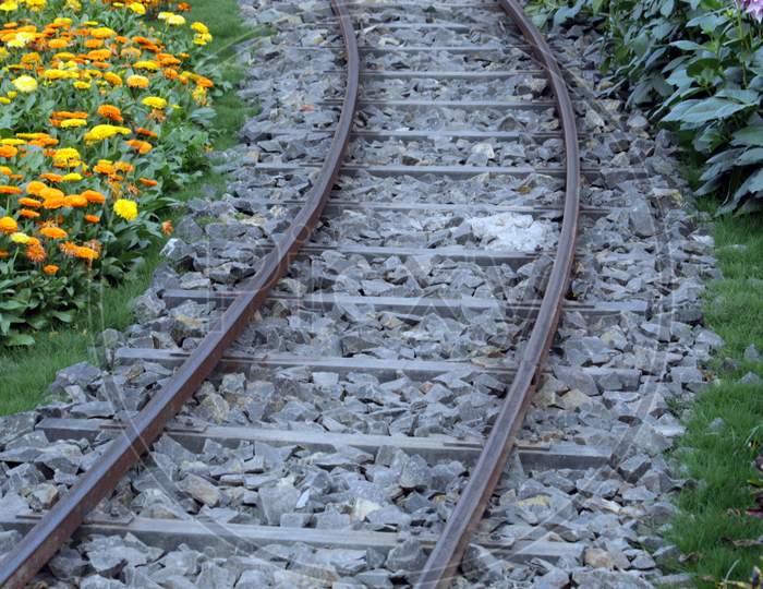 Railroad track or train lines closeup under bright sunlight.