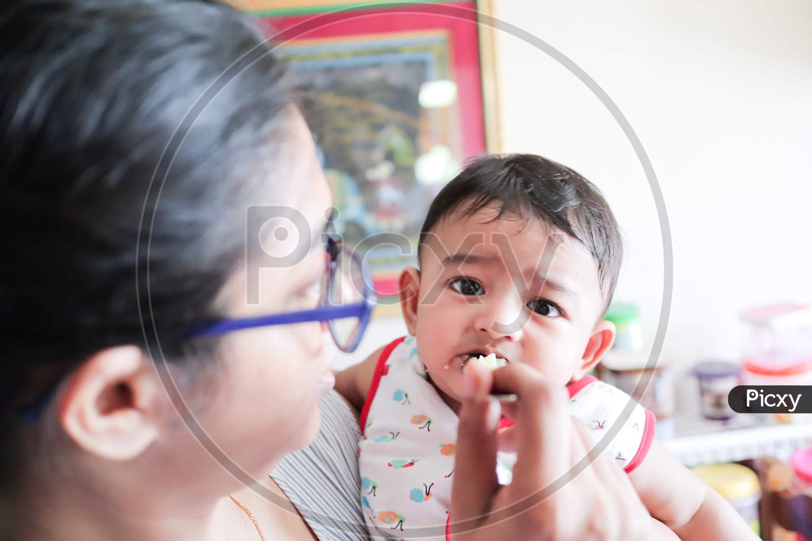 An Infant Toddler Baby Bonot Enjoying While Feeding Solid Food