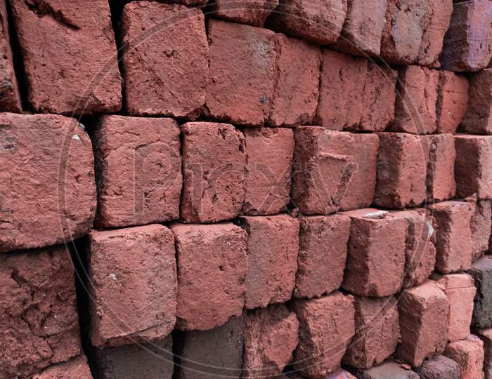 Stacked red bricks ready for construction，Toned image.