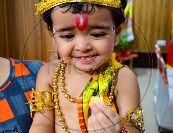 Cute Indian Kid dressed up as little Lord Krishna on the occasion of Krishna Janmastami Festival in Delhi India