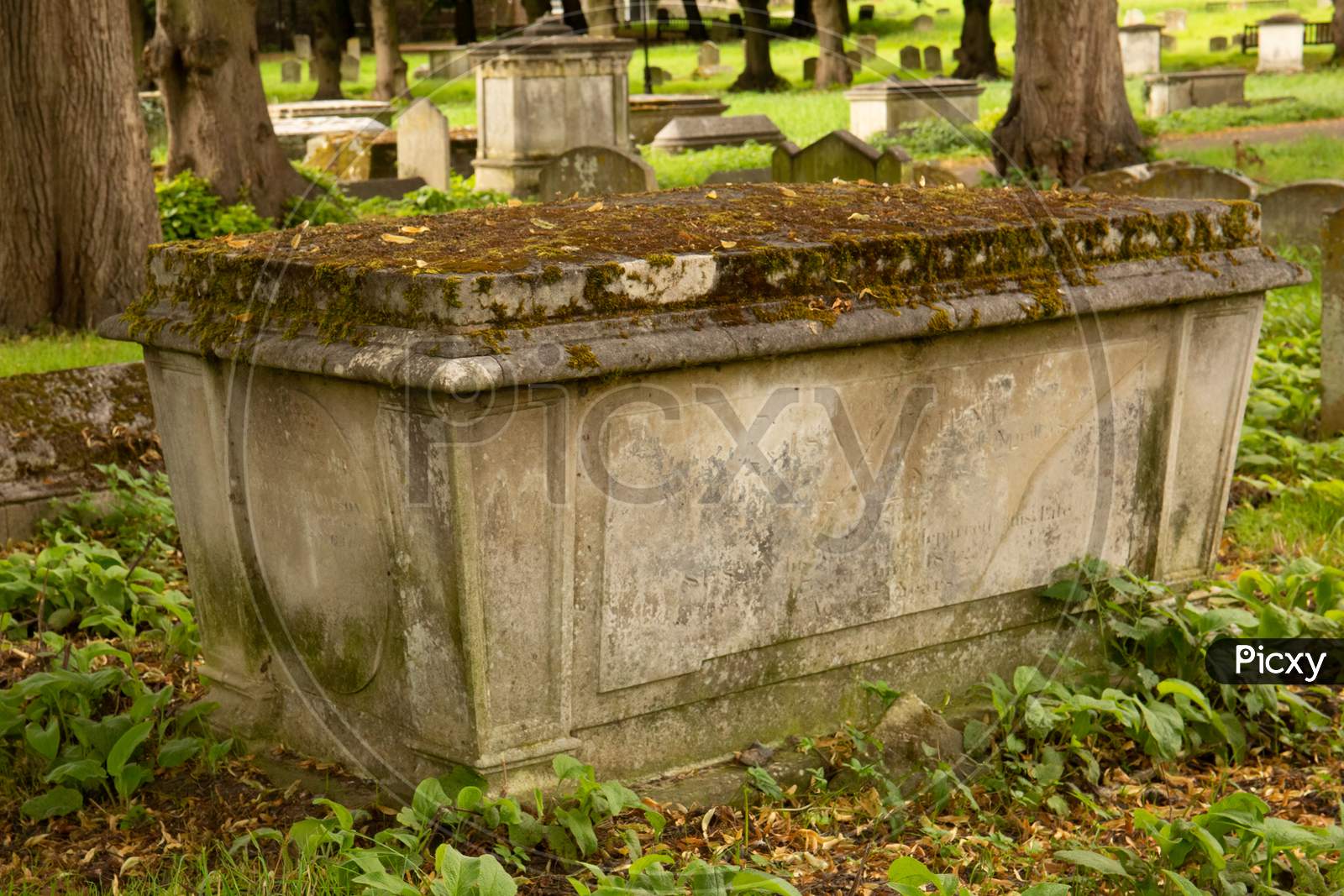 Classic weathered tomb monument in graveyard