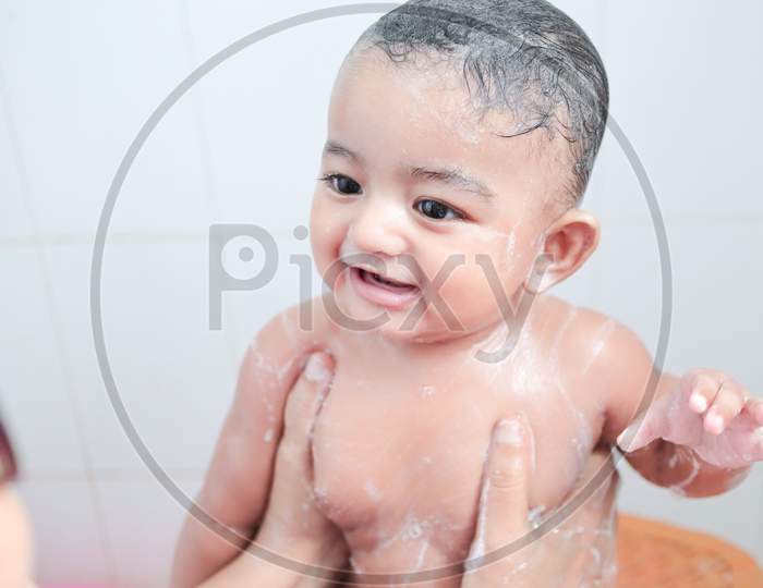 An Infant Toddler Baby Boy Wet With Foam Enjoying Shower Bathing