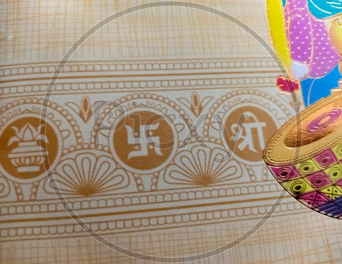 Swastik symbol on Indian traditional wedding invitation card. ohm symbol of Indian traditional.