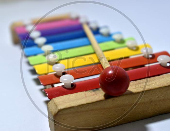 Rainbow colored toy xylophone isolated on white background. Bokeh - Shallow Depth of field.