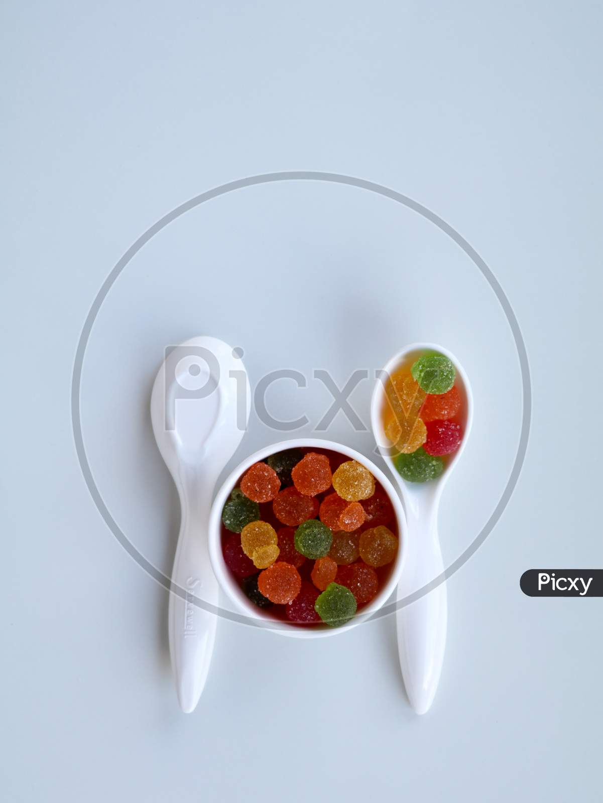 Sweet Mixed Color Jelly Candy In A White Spoon Against White Background With Copy Space