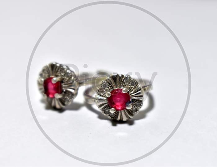 Women's silver toe ring with red gem stone isolated on the white background. Indian Oxide Jewellery Ethnic fashion traditional Jewellery.