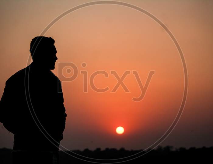 Man Looking at Sunset