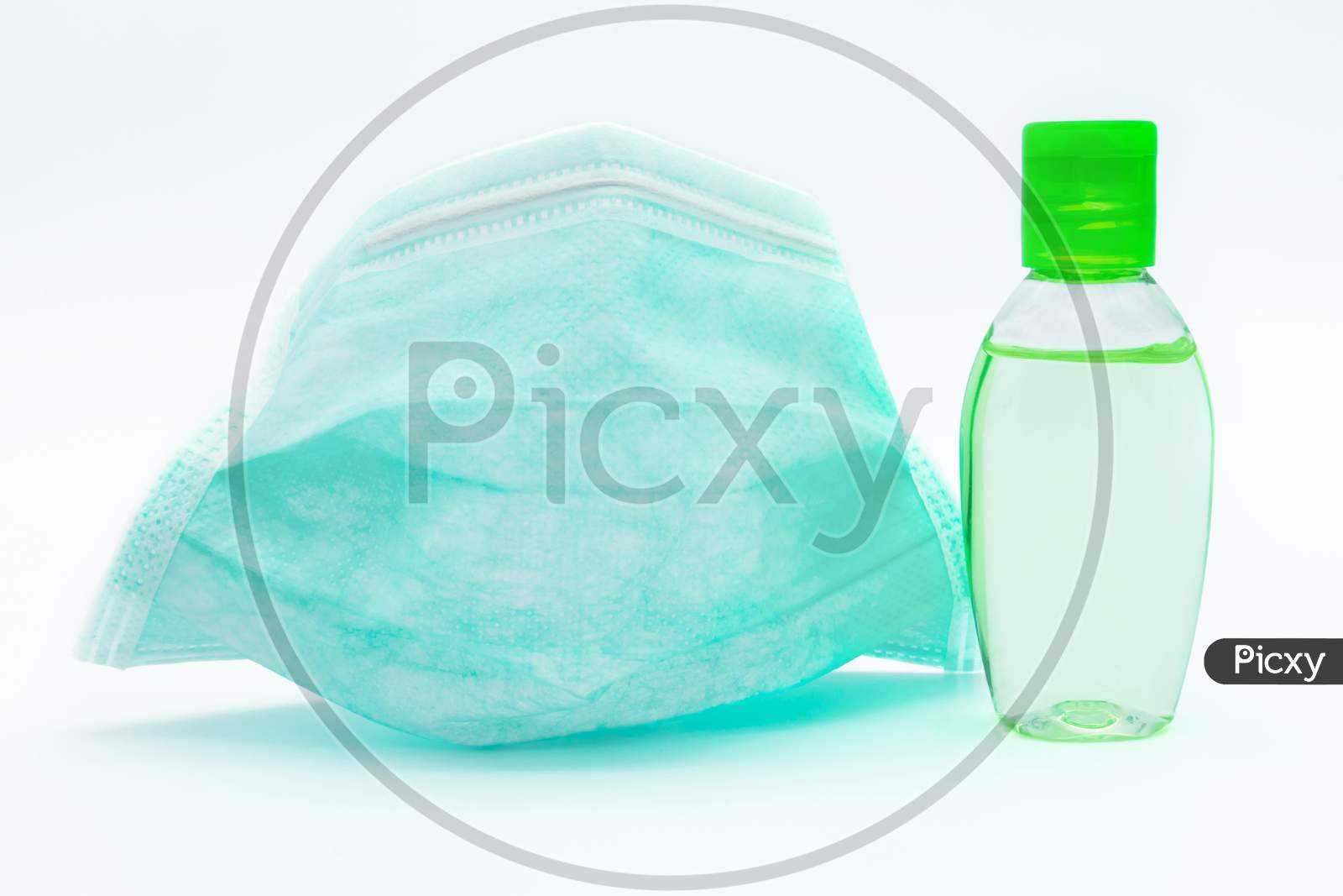 Surgical Face Mask And Bottle Of Hand Sanitizer Are Isolated On White Background