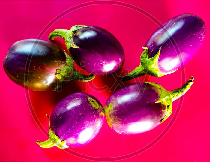 Four Eggplant Isolated On A Pink Background