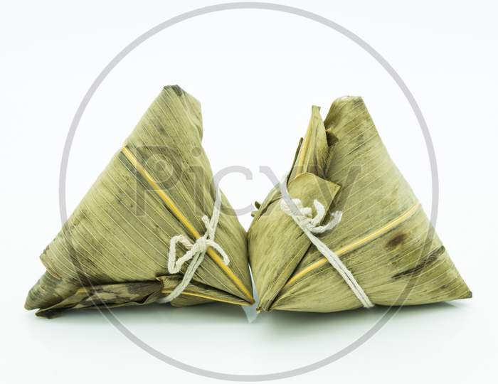 Closeup View Of The Zongzi (Sticky Rice Dumplings), It Is A Traditional Chinese Rice Dish Made Of Glutinous Rice Stuffed With Different Fillings And Wrapped In Reed Leaves.