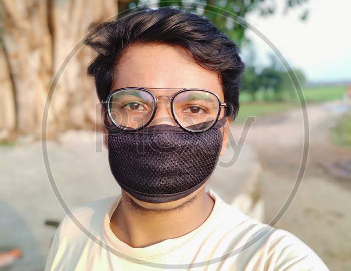 Patna, Bihar - 25 July,2020: Village boy selfie in face mask
